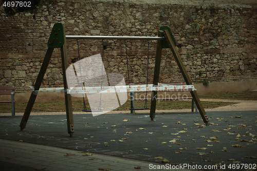 Image of Cordoned off A-frame swing in a kids playground