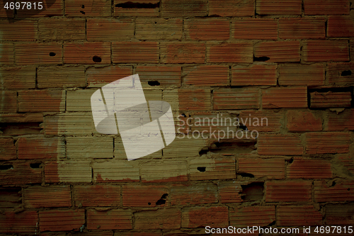 Image of Old damaged wall texture with striated red bricks