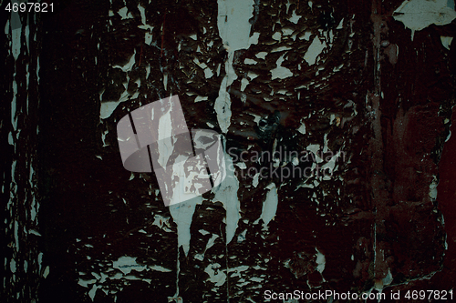 Image of Old weathered peeling black paint on wooden panel