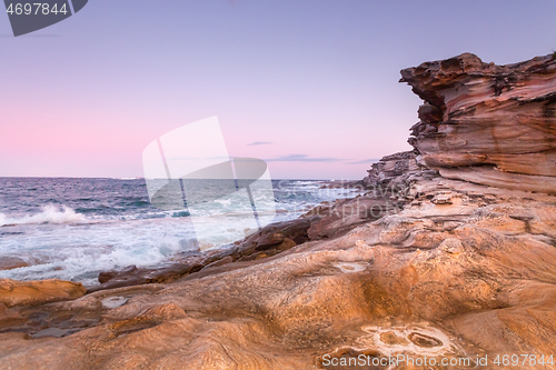 Image of Cool pink hues of dusk against warm hues of sandstone