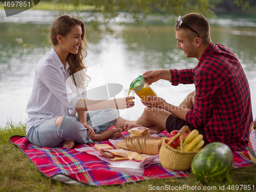 Image of Couple in love enjoying picnic time