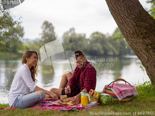 Image of Couple in love enjoying picnic time