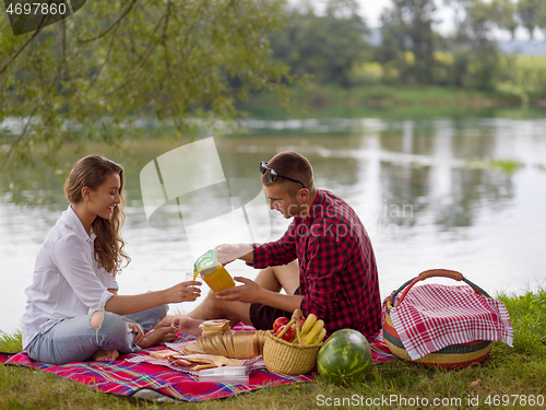 Image of Couple in love enjoying picnic time