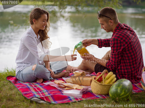 Image of Couple in love enjoying picnic time