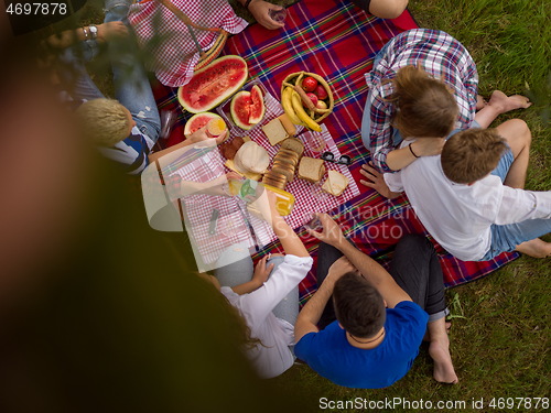 Image of top view of group friends enjoying picnic time