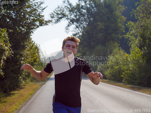 Image of man jogging along a country road