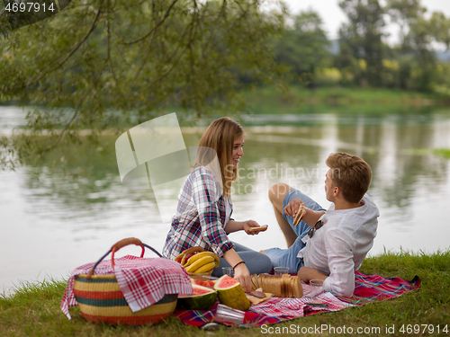 Image of Couple in love enjoying picnic time
