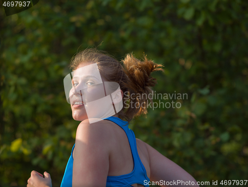 Image of woman jogging along a country road