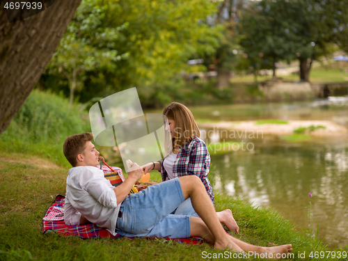 Image of Couple in love enjoying picnic time