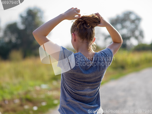 Image of woman jogging along a country road