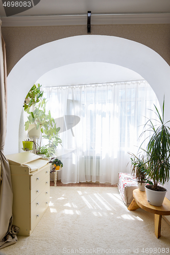 Image of Exit from the room in the form of an arch to a spacious glazed balcony