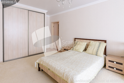 Image of Interior of a spacious, light, cozy bedroom