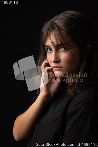 Image of Beautiful portrait of a young girl on a black background