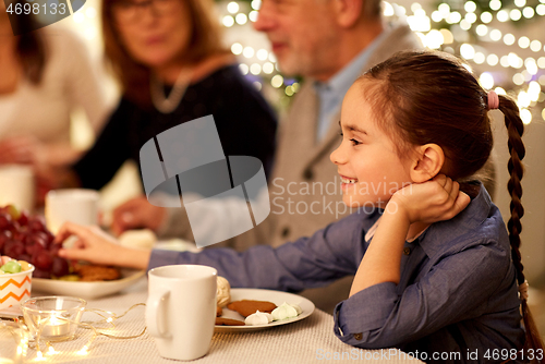 Image of happy girl having tea party with family at home