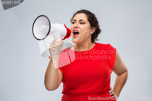Image of woman in red dress speaking to megaphone