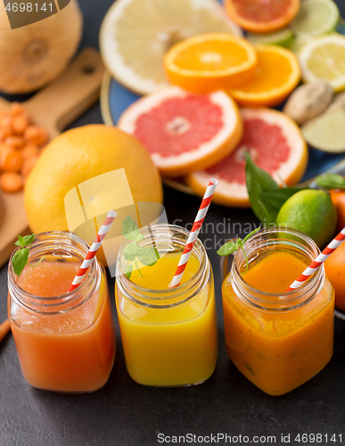 Image of mason jar glasses of vegetable juices on table