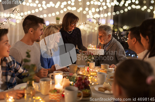 Image of happy family having birthday party at home