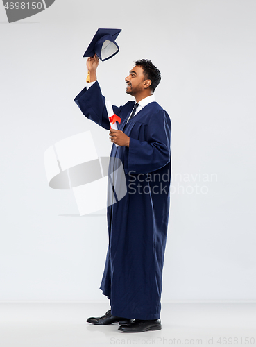 Image of male graduate student in mortar board with diploma