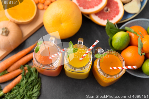 Image of mason jar glasses of vegetable juices on table