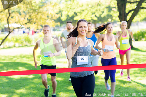 Image of happy young female runner on finish winning race