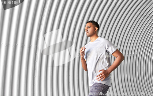 Image of sporty young man running in tunnel