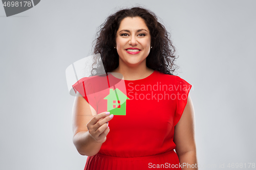 Image of happy woman in red dress holding green house icon