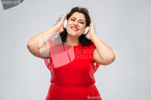 Image of happy woman in headphones listening to music