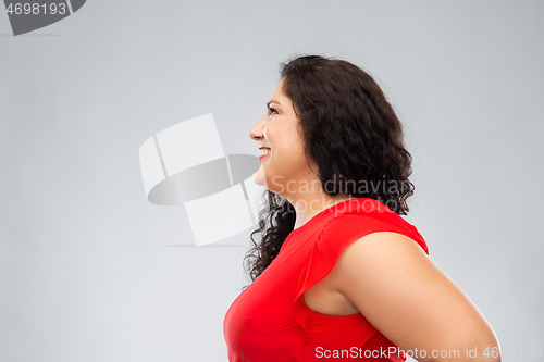 Image of happy smiling woman in red dress looking up