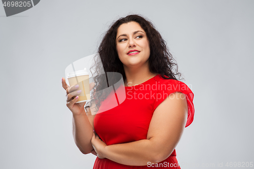 Image of woman in red dress holding takeaway coffee cup