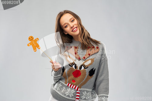 Image of woman in christmas sweater with reindeer pattern