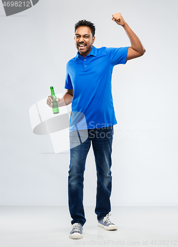 Image of male fan with beer bottle celebrating victory