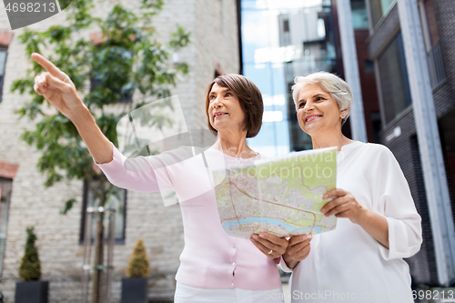 Image of senior women with city map on street in tallinn