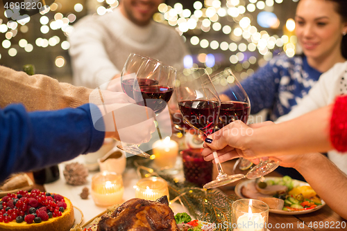 Image of close up of friends with wine celebrate christmas