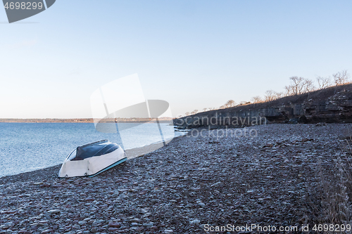 Image of Rowboat turned upside down by the coast