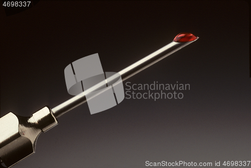Image of Drop of blood at the tip of a hypodermic needle