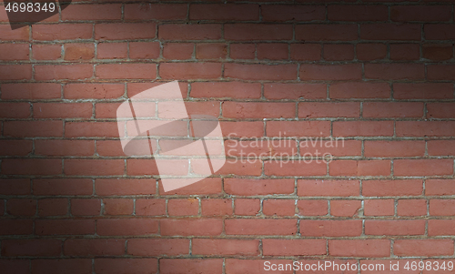 Image of Red brick wall background lit diagonally