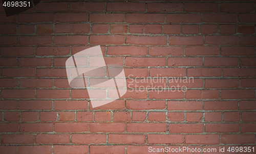 Image of Red brick wall background texture lit dramatically 