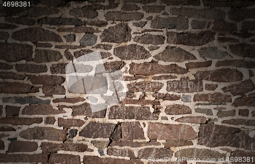 Image of Old masonry wall using irregular stones lit from above