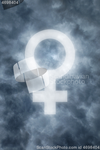 Image of Dark clouds with a glowing female symbol