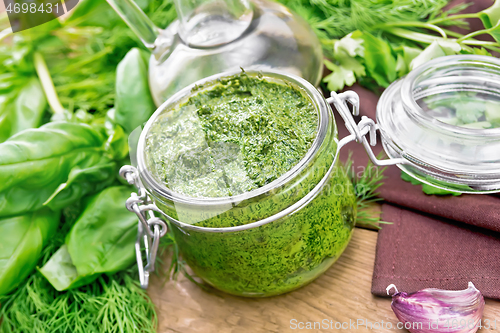 Image of Sauce of spicy greens in jar on board