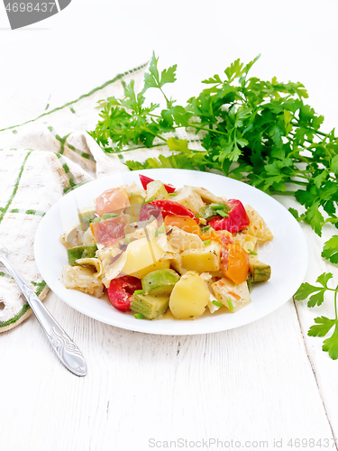 Image of Ragout vegetable with zucchini on white wooden board