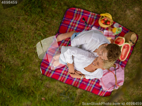 Image of top view of couple enjoying picnic time