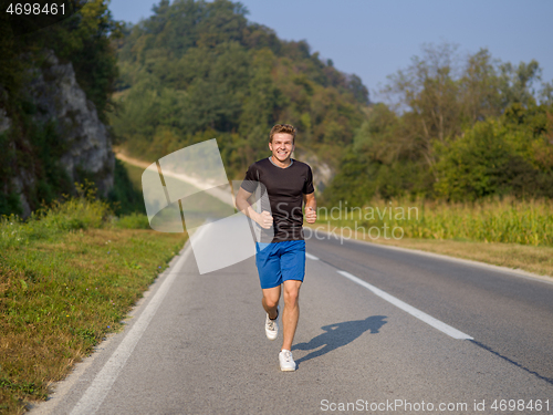 Image of man jogging along a country road