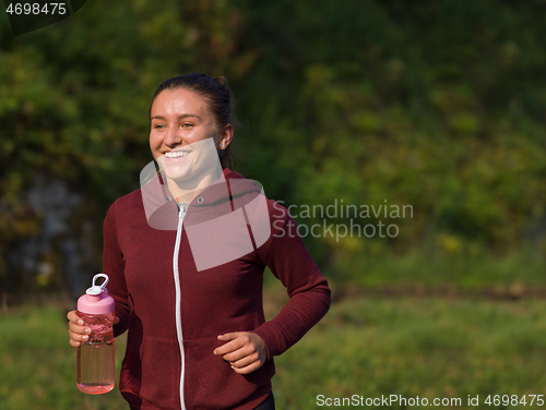 Image of woman jogging along a country road