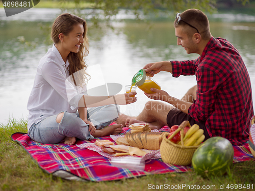 Image of Couple in love enjoying picnic time