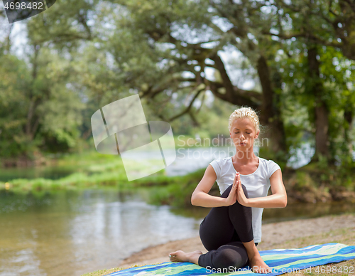 Image of woman meditating and doing yoga exercise