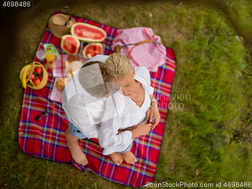 Image of top view of couple enjoying picnic time