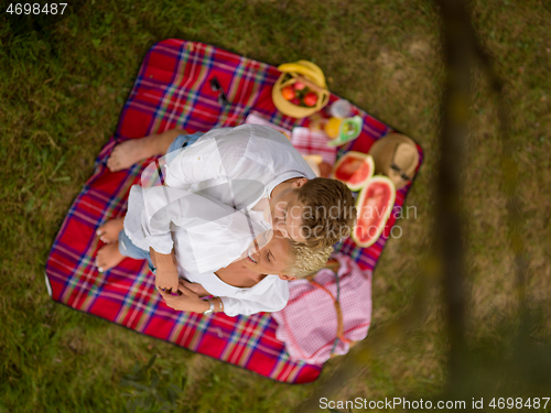 Image of top view of couple enjoying picnic time