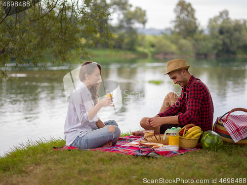 Image of Couple in love enjoying picnic time