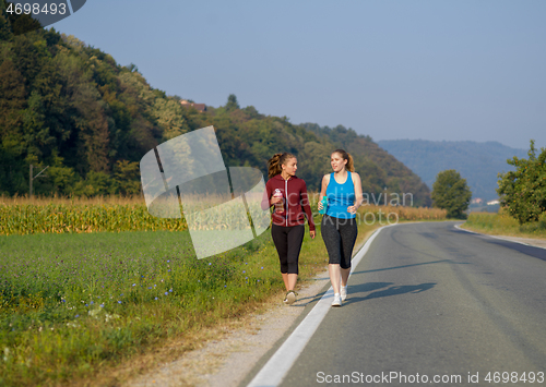 Image of women jogging along a country road